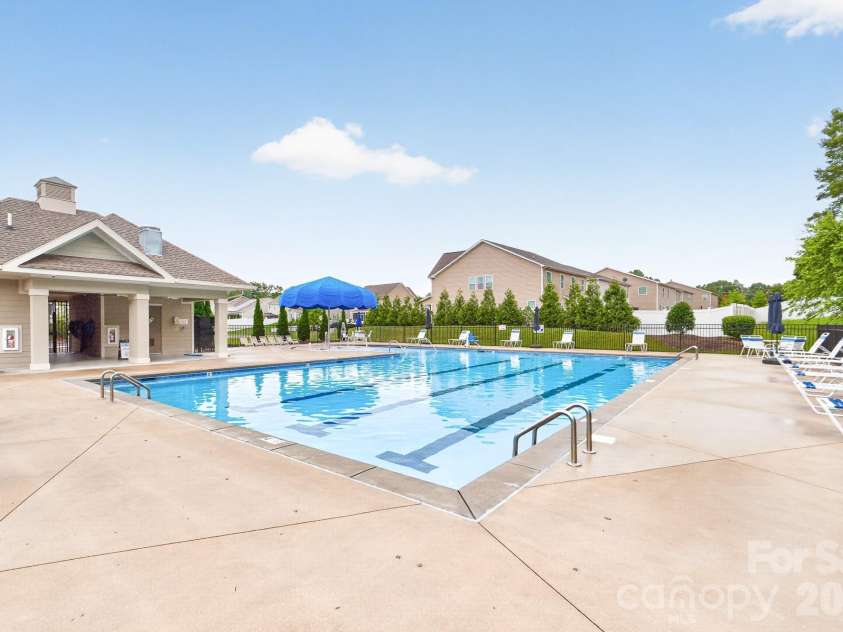 5972 Redwood Pine Road, Concord, NC 28027.  MLS# CAR4369260, YatesRealty ID 27977. This inviting pool with chairs and umbrellas