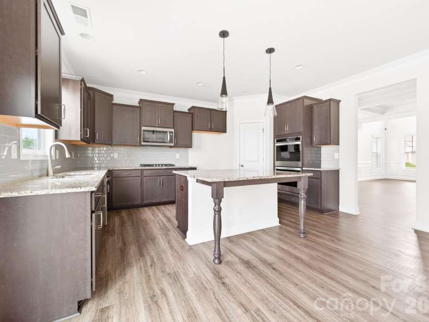 5972 Redwood Pine Road, Concord, NC 28027.  MLS# CAR4369260, YatesRealty ID 27977. Tile backsplash and a large pantry for extra storage