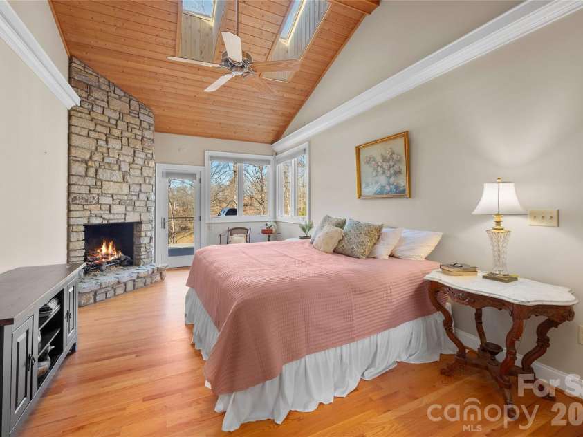 1552 Bear Creek Road, Leicester, NC 28748.  MLS# CAR4340462, YatesRealty ID 2799. Primary Bedroom w/ fireplace and deck access