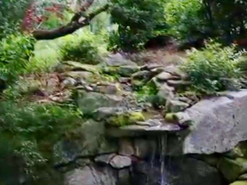 1552 Bear Creek Road, Leicester, NC 28748.  MLS# CAR4340462, YatesRealty ID 2799. Waterfall with pond 