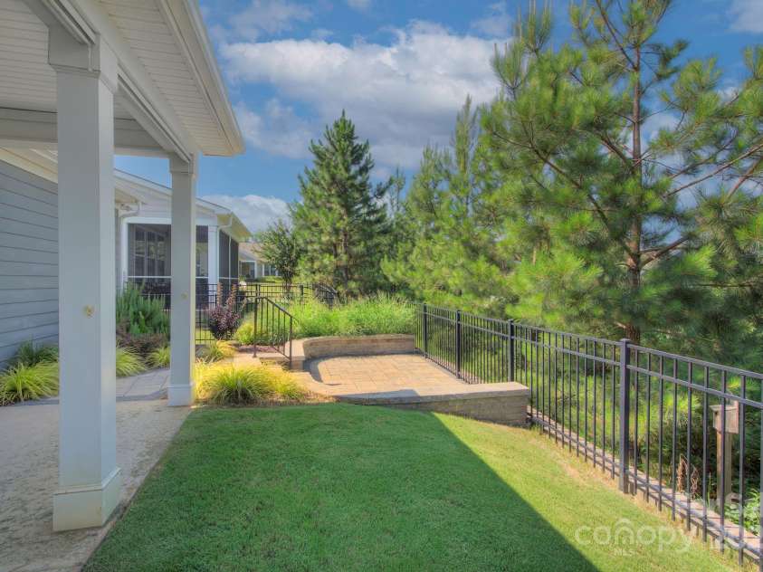 5527 Cheerful Lane, Charlotte, NC 28215.  MLS# CAR4275434, YatesRealty ID 28049. Fenced back yard-- lawn maintenance included in back yard.  There is a nice step down paver patio that will accomodate a firepit/ chairs/ table/chairs- whatever you choose.  The paver patio was approved by the neighborh