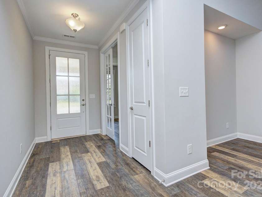 5527 Cheerful Lane, Charlotte, NC 28215.  MLS# CAR4275434, YatesRealty ID 28049. Front entryway- front door with privacy, coat closet and French door entrance to the office area