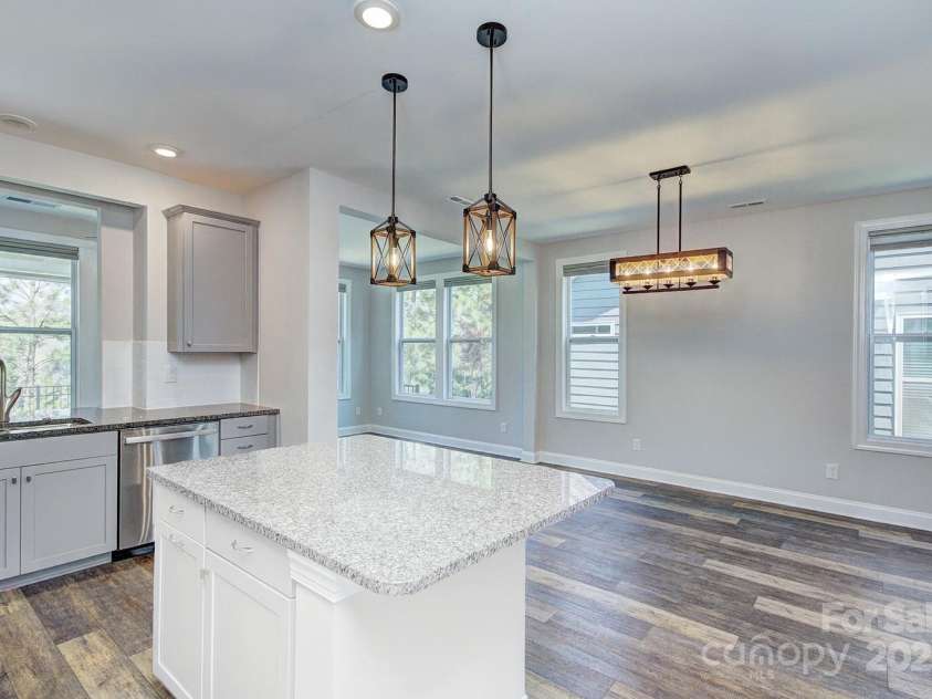 5527 Cheerful Lane, Charlotte, NC 28215.  MLS# CAR4275434, YatesRealty ID 28049. Open to the eat in dining area with linear light fixture- the space can fit a large extended dining table for great entertaining    