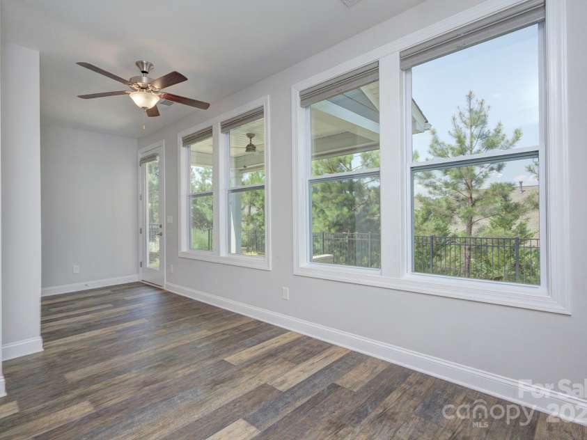5527 Cheerful Lane, Charlotte, NC 28215.  MLS# CAR4275434, YatesRealty ID 28049. Sunroom has a pass through from the kitchen, great natural light, ceiling fan- perfect area for puzzles/games/crafting
