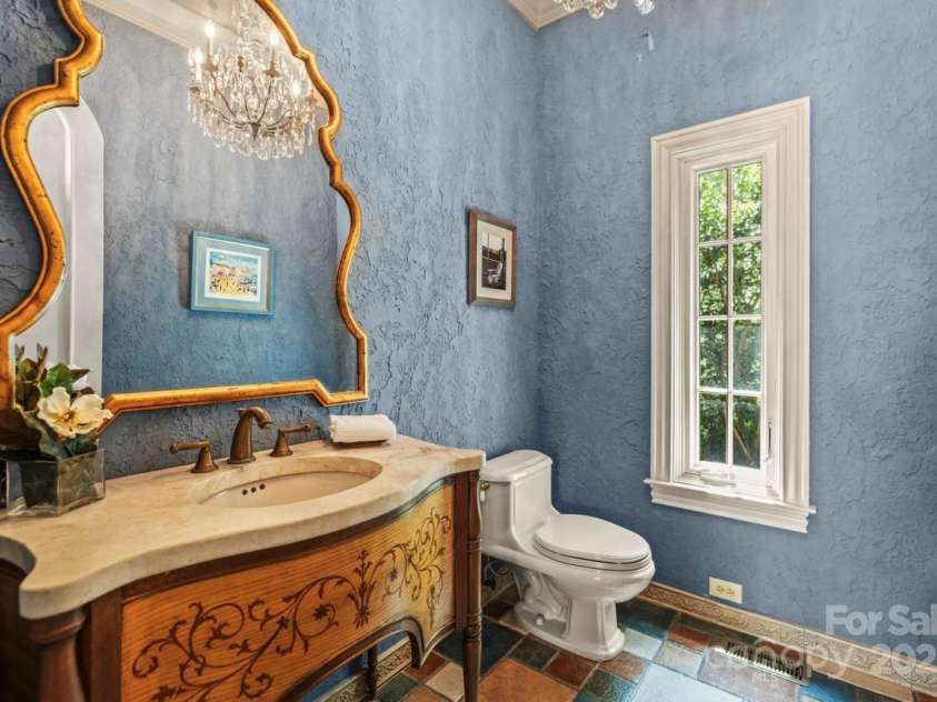 343 Wester Brewlands Road, Iron Station, NC 28080.  MLS# CAR4284507, YatesRealty ID 28060. 4 Half Bathrooms! Guests will enjoy the carefully placed half bathrooms that provide unique details and finishes, including the impressive vanity and crystal chandelier seen here