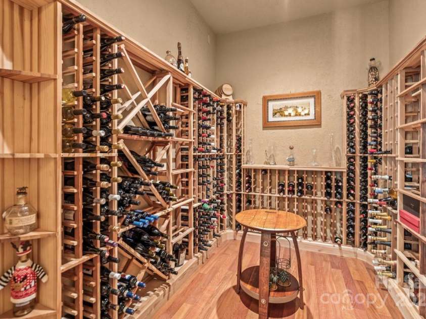 343 Wester Brewlands Road, Iron Station, NC 28080.  MLS# CAR4284507, YatesRealty ID 28060. A Collectors Dream! Showcasing custom wood racks and a separate wine chiller, this impressive wine cellar is designed to store and display your finest bottles in a temperature-controlled environment—perfect fo