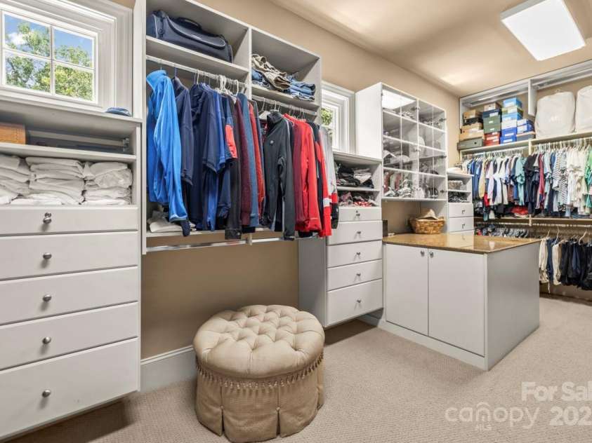 343 Wester Brewlands Road, Iron Station, NC 28080.  MLS# CAR4284507, YatesRealty ID 28060. Amazing Primary Closet!A true walk-in wardrobe! This custom-designed closet offers built-in organization, ample hanging space, drawers, display shelving, and a center island—an exceptional blend of style and s