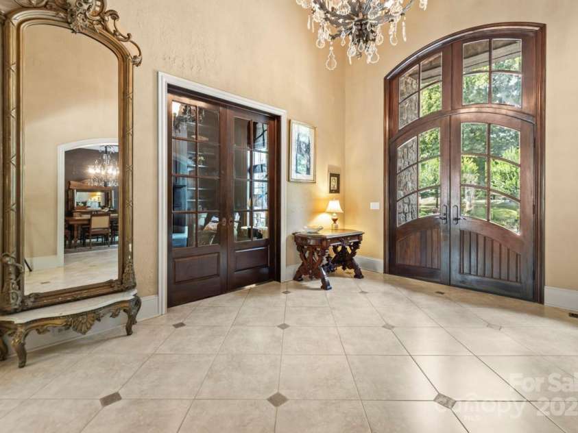 343 Wester Brewlands Road, Iron Station, NC 28080.  MLS# CAR4284507, YatesRealty ID 28060. An elegant welcome! This soaring foyer features a custom arched double-door entry, crystal chandelier, and timeless architectural details