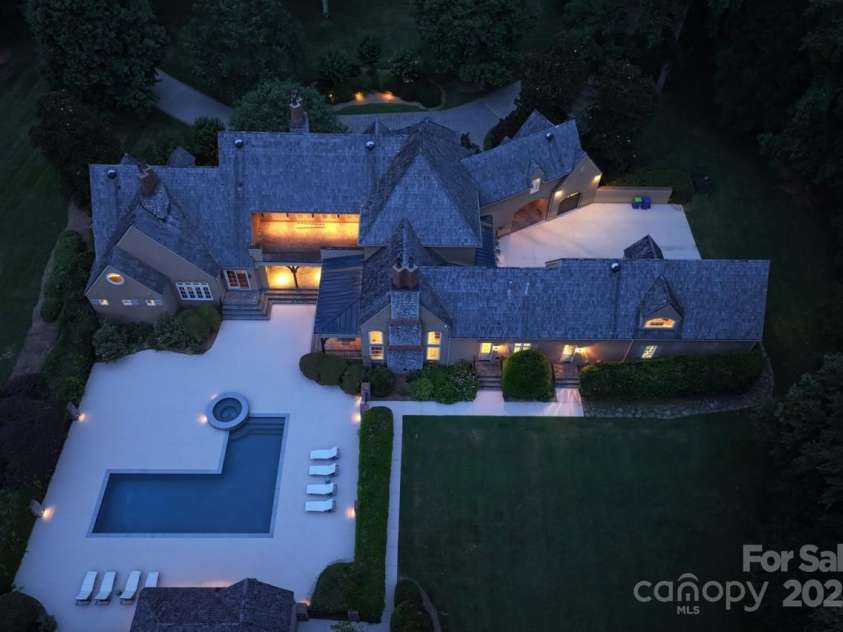 343 Wester Brewlands Road, Iron Station, NC 28080.  MLS# CAR4284507, YatesRealty ID 28060. Architectural Masterpiece! Beautifully captured dusk view of this French Provincial estate showcasing its striking rooflines and expansive footprint