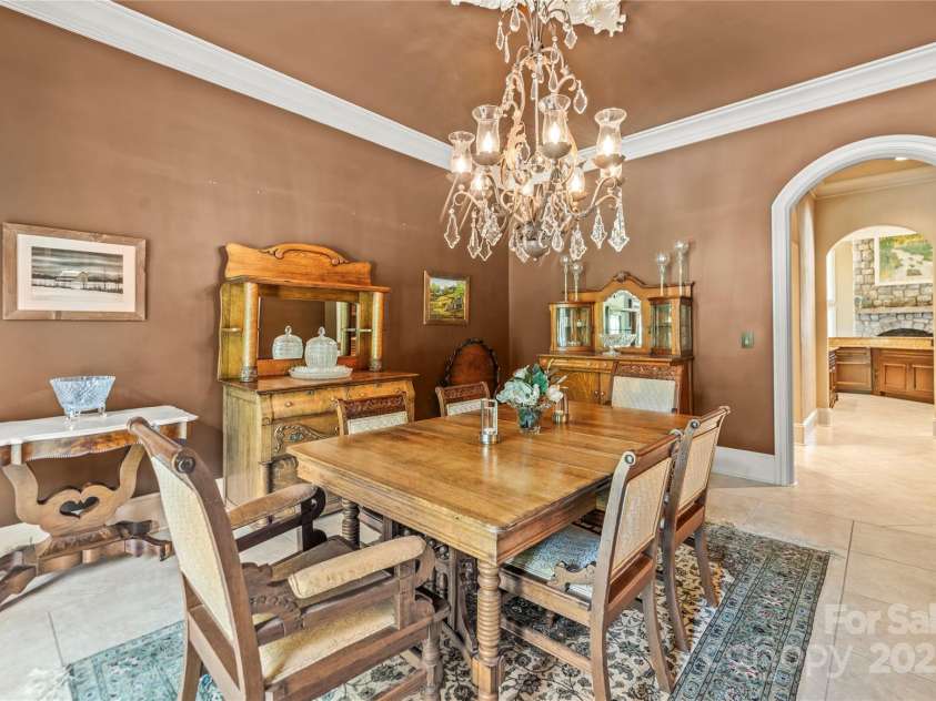 343 Wester Brewlands Road, Iron Station, NC 28080.  MLS# CAR4284507, YatesRealty ID 28060. Classic charm meets refined elegance in this formal dining room! Highlighted by rich wall tones, a crystal chandelier, and antique-inspired millwork perfect for hosting intimate dinners or festive gatherings