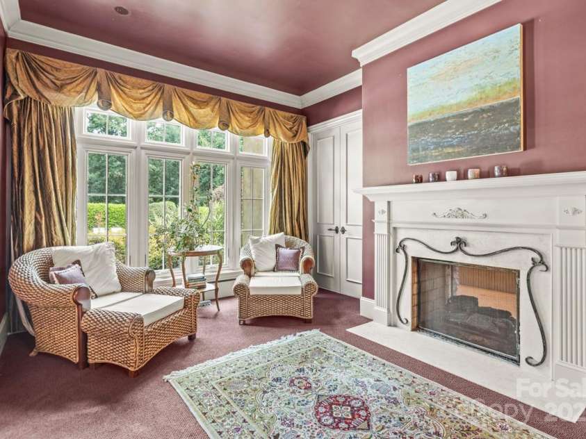 343 Wester Brewlands Road, Iron Station, NC 28080.  MLS# CAR4284507, YatesRealty ID 28060. Elegant Bedroom Sanctuary!Rich, custom drapery, plush carpet, and a cozy fireplace create a warm, inviting atmosphere, while French doors lead directly to the pool and courtyard
