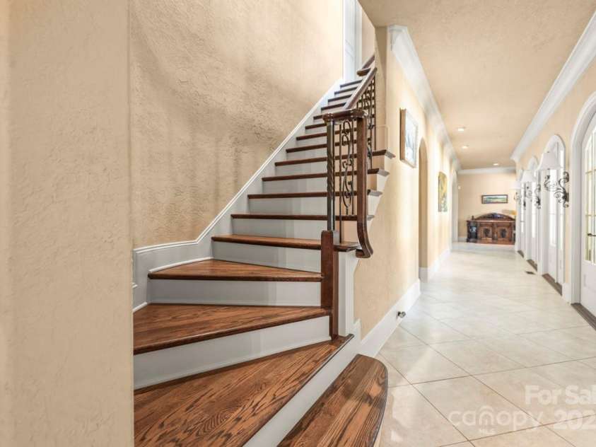 343 Wester Brewlands Road, Iron Station, NC 28080.  MLS# CAR4284507, YatesRealty ID 28060. Elegant Staircase! A dramatic curved staircase with cherry wood treads and iron balusters makes a lasting impression—blending craftsmanship and grace as it leads to the home’s upper level