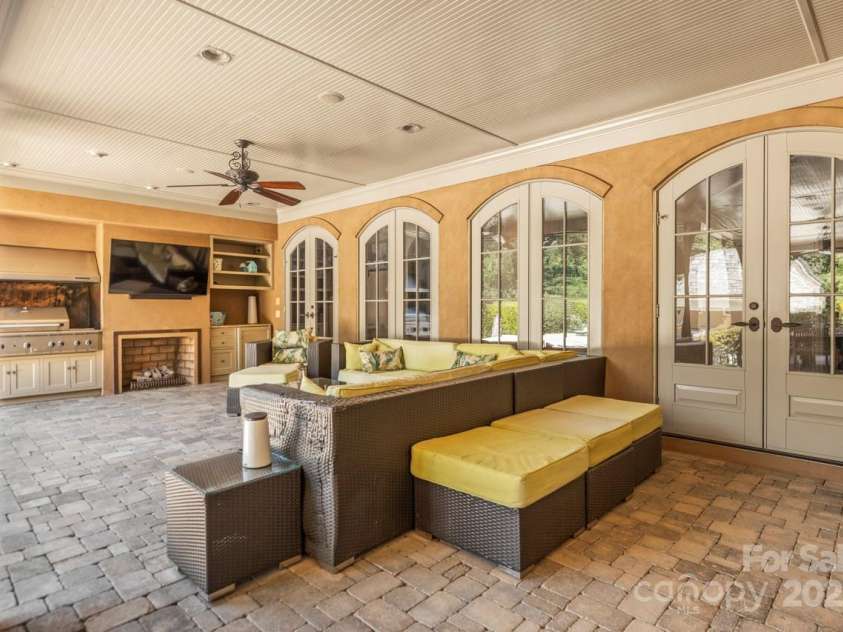 343 Wester Brewlands Road, Iron Station, NC 28080.  MLS# CAR4284507, YatesRealty ID 28060. Outdoor fireplace and Covered Patio! Complete with built-in gas grill, custom cabinetry, fireplace, and wall-mounted TV—ideal for year-round entertaining and game day gatherings.