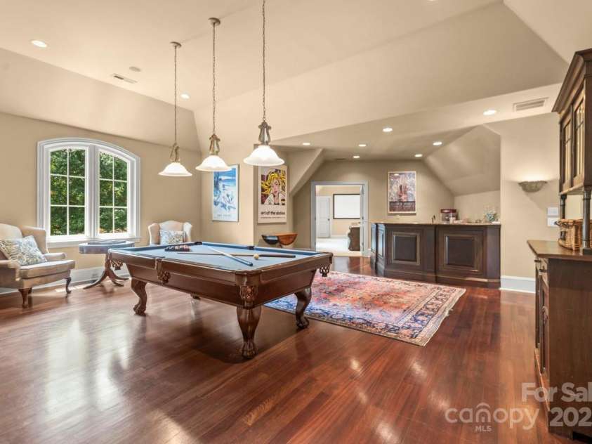 343 Wester Brewlands Road, Iron Station, NC 28080.  MLS# CAR4284507, YatesRealty ID 28060. Recreation Room with Bar! The ultimate space for entertaining—this billiards room boasts gleaming hardwood floors, a full-service wet bar, and stylish pendant lighting for elevated game nights