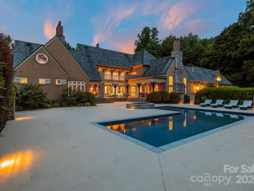 343 Wester Brewlands Road, Iron Station, NC 28080.  MLS# CAR4284507, YatesRealty ID 28060. Resort-style living at its finest! This breathtaking rear elevation showcases the covered veranda and dramatic architectural lines all perfectly framed by lush, private woodlands