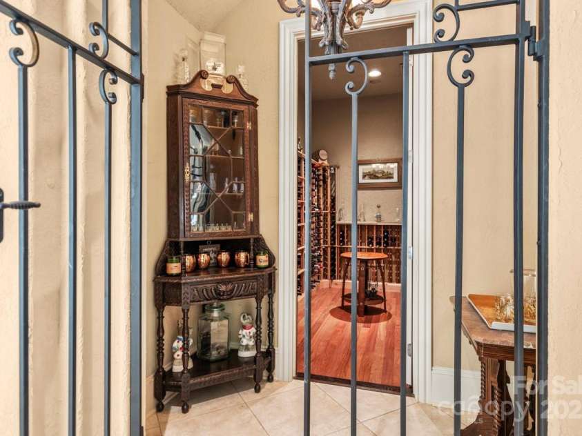 343 Wester Brewlands Road, Iron Station, NC 28080.  MLS# CAR4284507, YatesRealty ID 28060. Sip and Savor!Tucked behind elegant wrought iron doors, this intimate wine tasting room blends Old World charm with refined functionality. Custom wood racks, warm lighting, and timeless finishes create a perfe