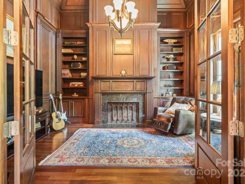 343 Wester Brewlands Road, Iron Station, NC 28080.  MLS# CAR4284507, YatesRealty ID 28060. Sophisticated home office featuring rich mahogany built-ins, and walls with cherry hardwood floors, soaring vaulted ceilings, and a stately fireplace. This masterpiece offers an inspiring space for productivit