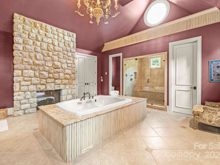 343 Wester Brewlands Road, Iron Station, NC 28080.  MLS# CAR4284507, YatesRealty ID 28060. Spa-Inspired Bathroom! Indulge in the oversized jetted tub framed in granite, towel warmer, double vanities with custom cabinetry, oversized tile steam shower with bench seating and a stone fireplace that adds