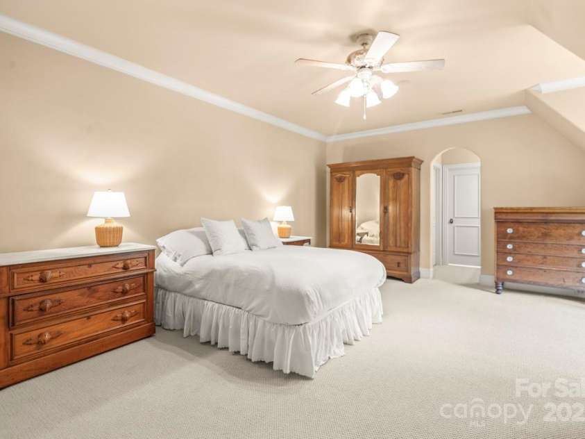 343 Wester Brewlands Road, Iron Station, NC 28080.  MLS# CAR4284507, YatesRealty ID 28060. Upper level Retreat! This generously sized third bedroom offers privacy and comfort on the upper level, perfect for guests or extended stays. Neutral tones and charming architectural angles add warmth and char