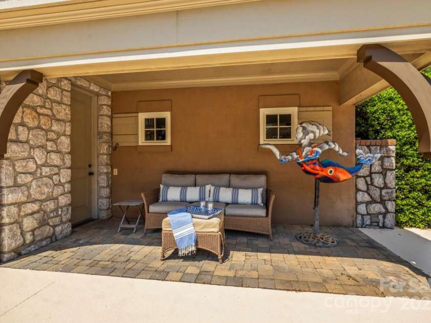343 Wester Brewlands Road, Iron Station, NC 28080.  MLS# CAR4284507, YatesRealty ID 28060. Your Private Poolside Retreat! Relax in the shade and enjoy resort-style lounging just steps from the pool in this inviting covered seating area, tucked under the charming stone and stucco pool house