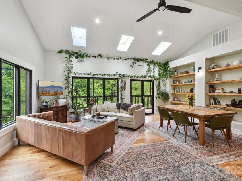 906 Merrills Cove Road, Asheville, NC 28803.  MLS# CAR4264221, YatesRealty ID 28089. Expansive windows in living room