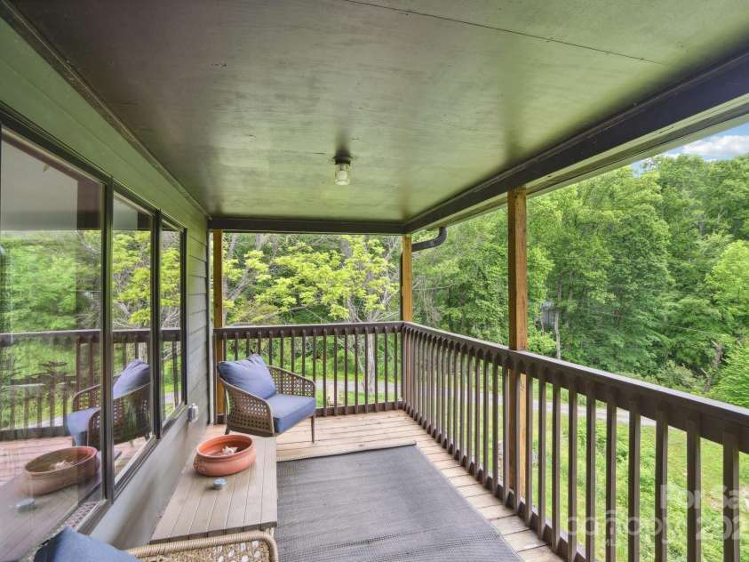 906 Merrills Cove Road, Asheville, NC 28803.  MLS# CAR4264221, YatesRealty ID 28089. Main level deck looking towards entry drive