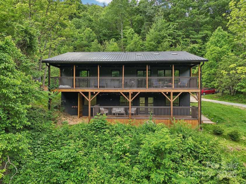 906 Merrills Cove Road, Asheville, NC 28803.  MLS# CAR4264221, YatesRealty ID 28089. View of house from pond are