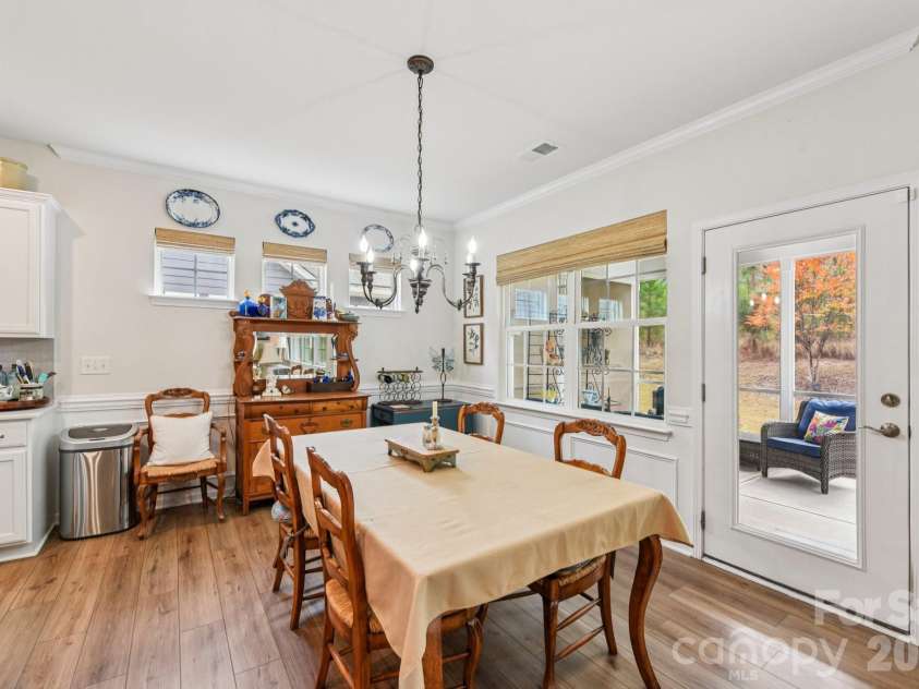 1328 Dali Boulevard, Mount Holly, NC 28120.  MLS# CAR4376476, YatesRealty ID 28096. Dining area in direct proximity to the kitchen and features updated lighting and automatic window shades!
