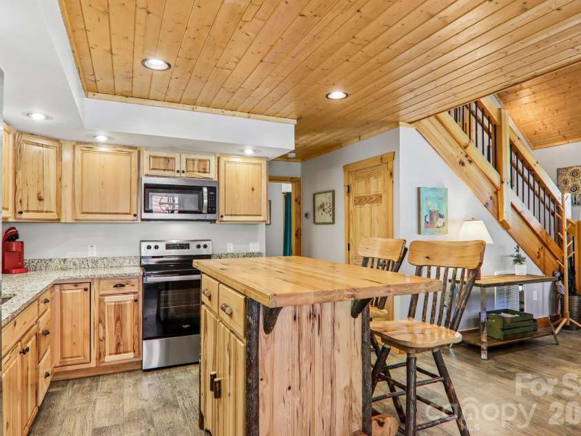 589 Panoramic Loop, Maggie Valley, NC 28751.  MLS# CAR4372216, YatesRealty ID 28097. Kitchen Island with butcher block top and log accents