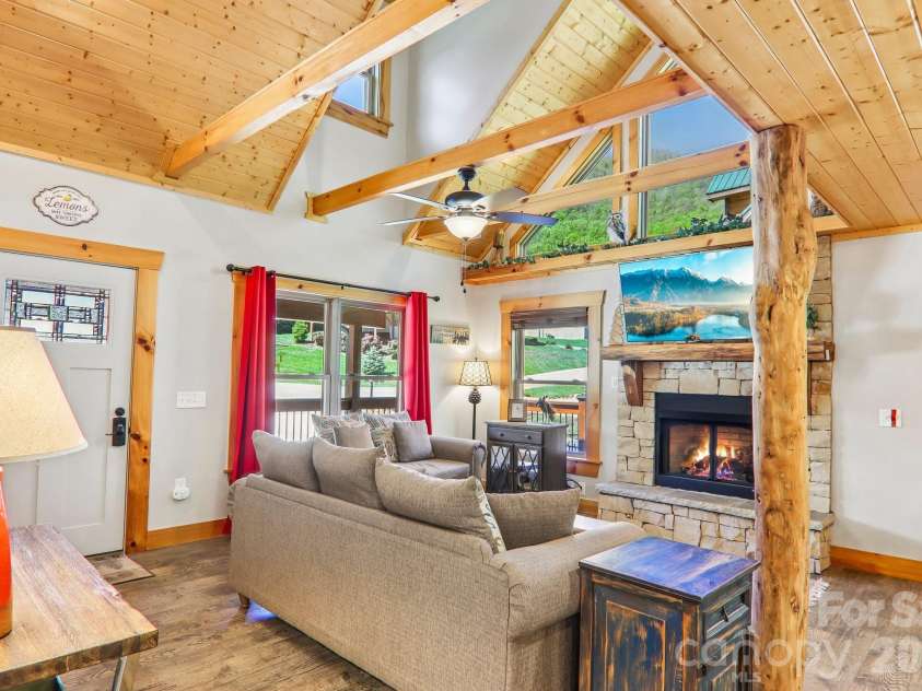 589 Panoramic Loop, Maggie Valley, NC 28751.  MLS# CAR4372216, YatesRealty ID 28097. Vaulted great room with window for the view and stove faced fireplace
