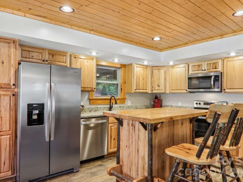 589 Panoramic Loop, Maggie Valley, NC 28751.  MLS# CAR4372216, YatesRealty ID 28097. Wood cabinets are a beautiful upgrade - with stainless appliances