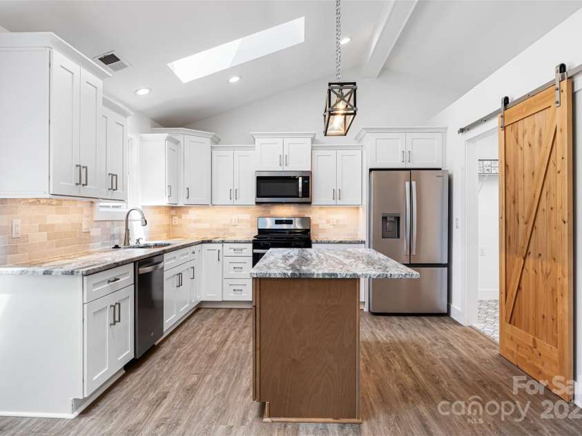 2027 Marquesas Avenue, Tega Cay, SC 29708.  MLS# CAR4262769, YatesRealty ID 28103. Kitchen has doors to Laundry