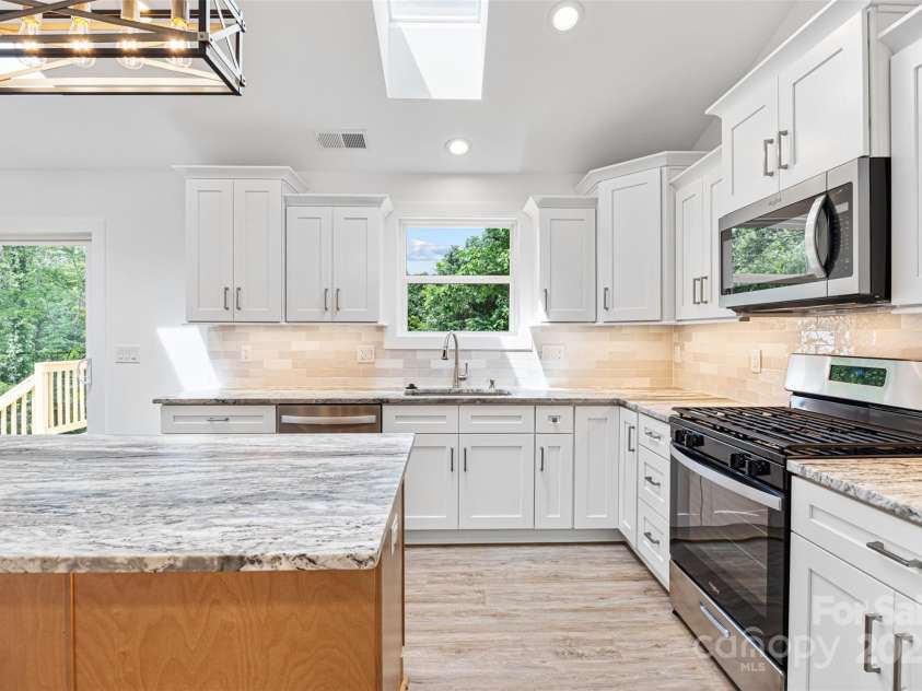 2027 Marquesas Avenue, Tega Cay, SC 29708.  MLS# CAR4262769, YatesRealty ID 28103. Kitchen with leathered granite countertops