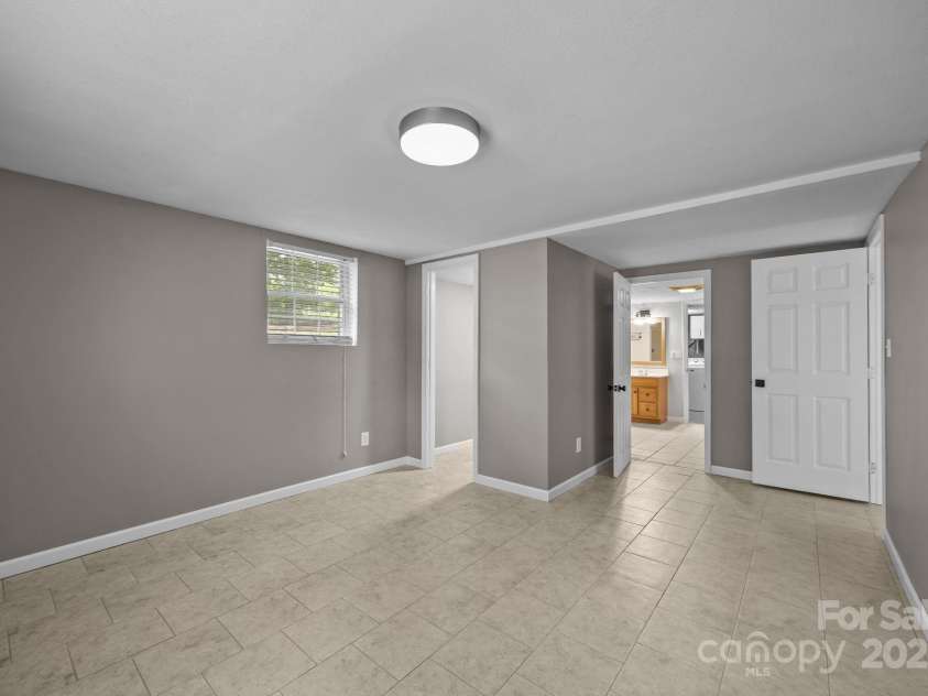 117 BeechTree Drive, Black Mountain, NC 28711.  MLS# CAR4281681, YatesRealty ID 28106. Downstairs bedroom connecting to bath