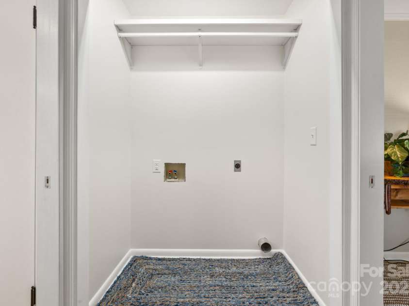 211 Woodland Road, Tryon, NC 28782.  MLS# CAR4274932, YatesRealty ID 28116. Laundry closet across from WIC
