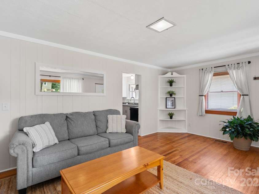 211 Woodland Road, Tryon, NC 28782.  MLS# CAR4274932, YatesRealty ID 28116. Living Room, hardwood floors