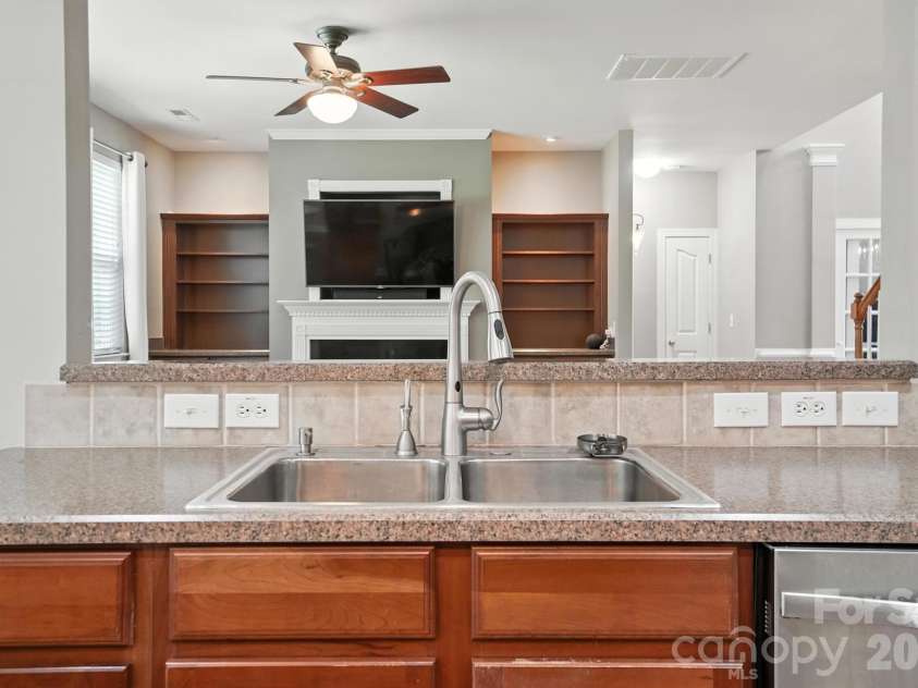 4819 Sandtyn Drive, Waxhaw, NC 28173.  MLS# CAR4282295, YatesRealty ID 28120. Kitchen with bar area to family room