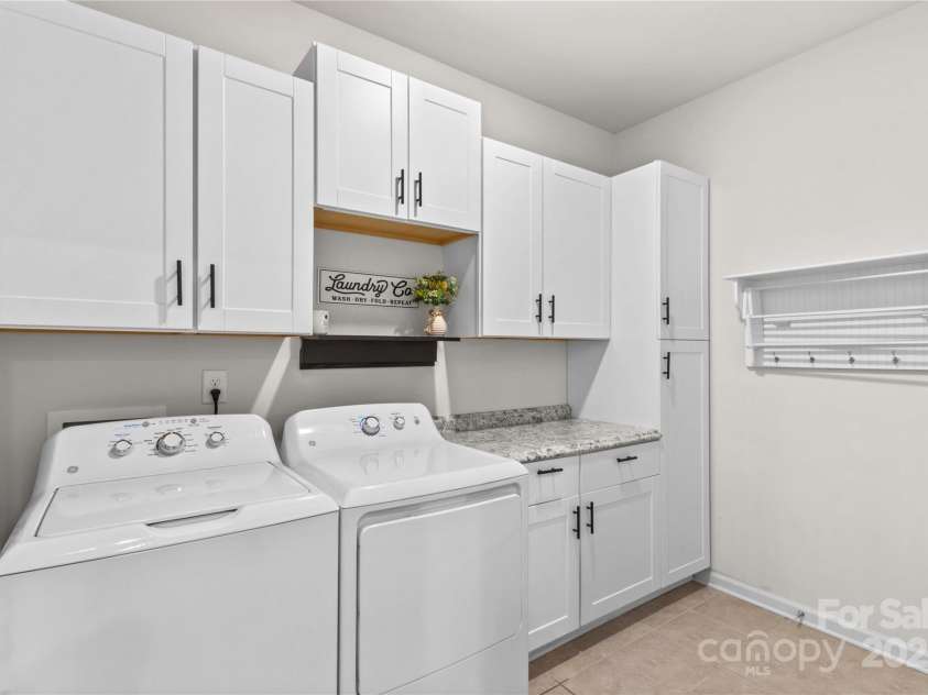 14036 Asbury Park Road, Huntersville, NC 28078.  MLS# CAR4283671, YatesRealty ID 28122. Large laundry room with storage