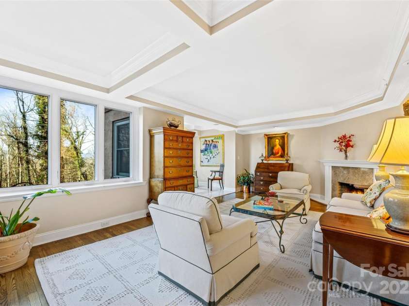 185 Macon Avenue, Asheville, NC 28804.  MLS# CAR4329475, YatesRealty ID 28133. Living room with fireplace and large windows.