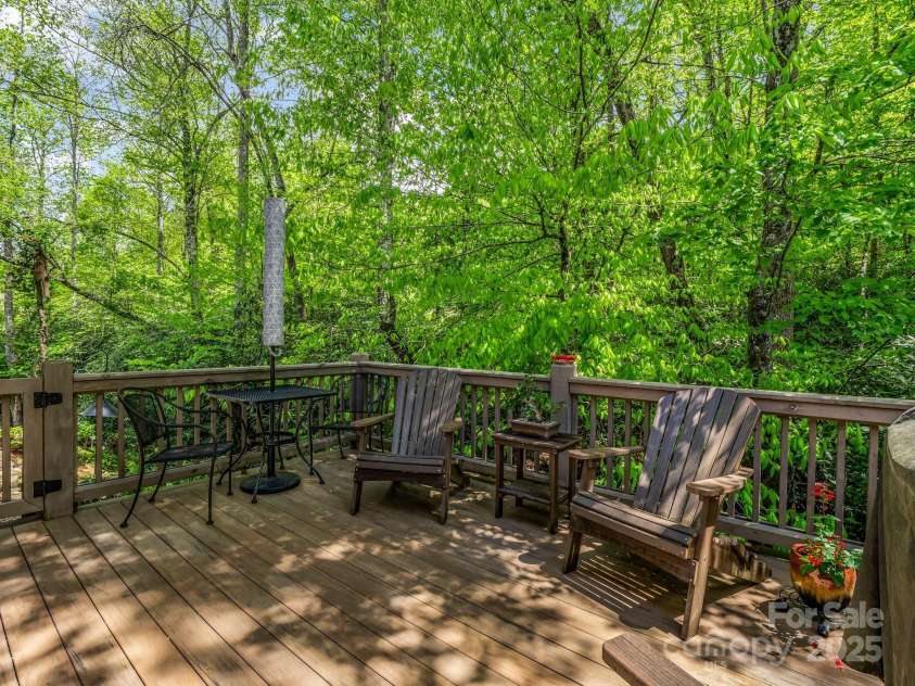29 Stonehollow Lane, Brevard, NC 28712.  MLS# CAR4282263, YatesRealty ID 28142. Deck facing private wooded area and creek