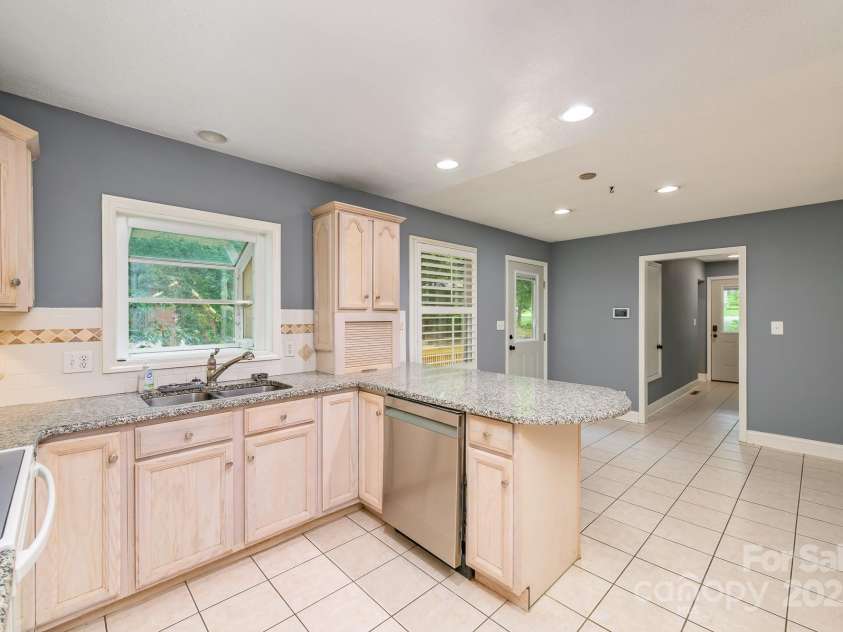 103 Sycamore Road, Salisbury, NC 28147.  MLS# CAR4265869, YatesRealty ID 28144. Kitchen looking dining and right hallway which shows another entrance into the home from driveway.