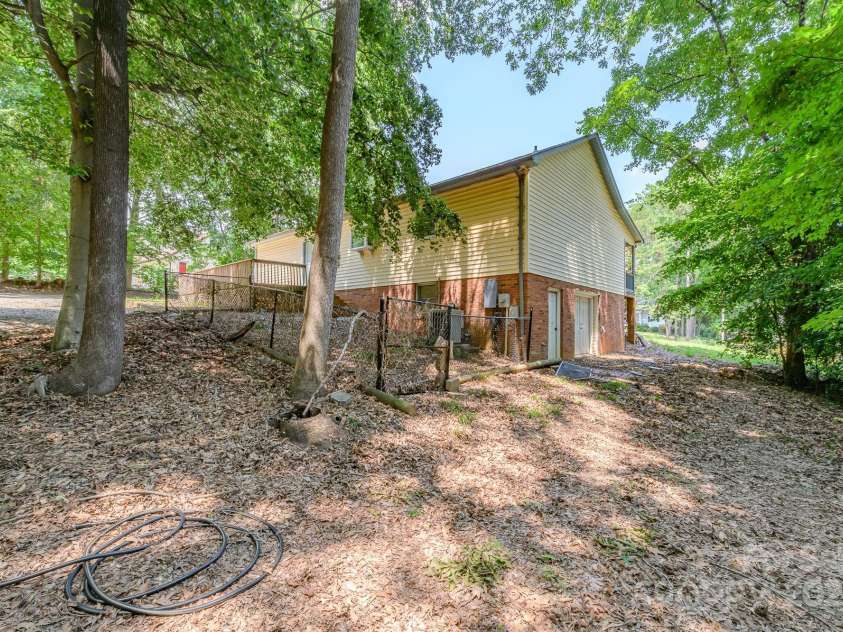 103 Sycamore Road, Salisbury, NC 28147.  MLS# CAR4265869, YatesRealty ID 28144. Left side of back yard showing double doors into basement.