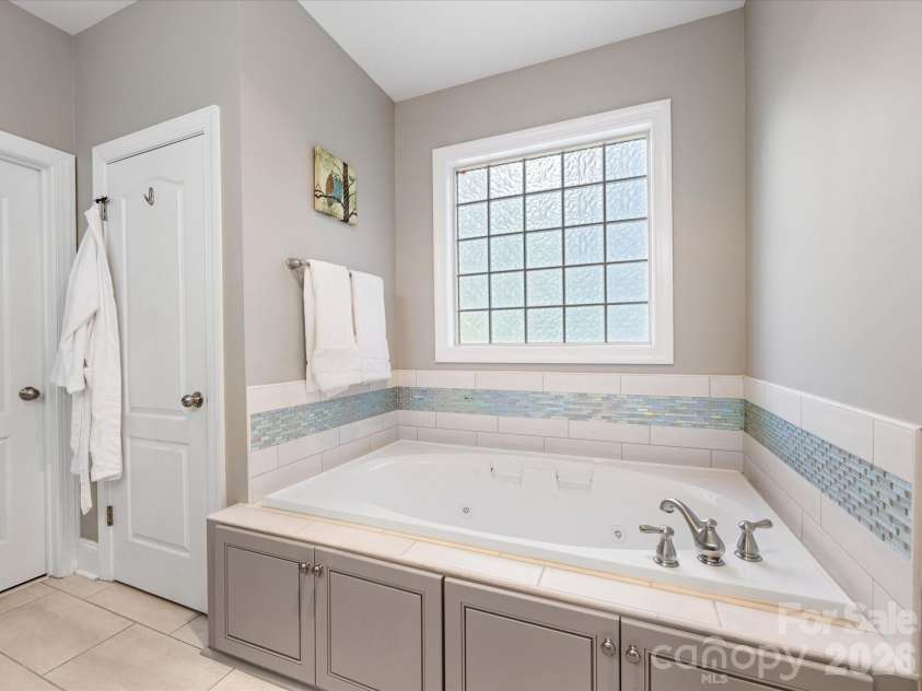 9311 Scorpio Lane, Mint Hill, NC 28227.  MLS# CAR4372655, YatesRealty ID 28169. Jetted large tub with tile accents!