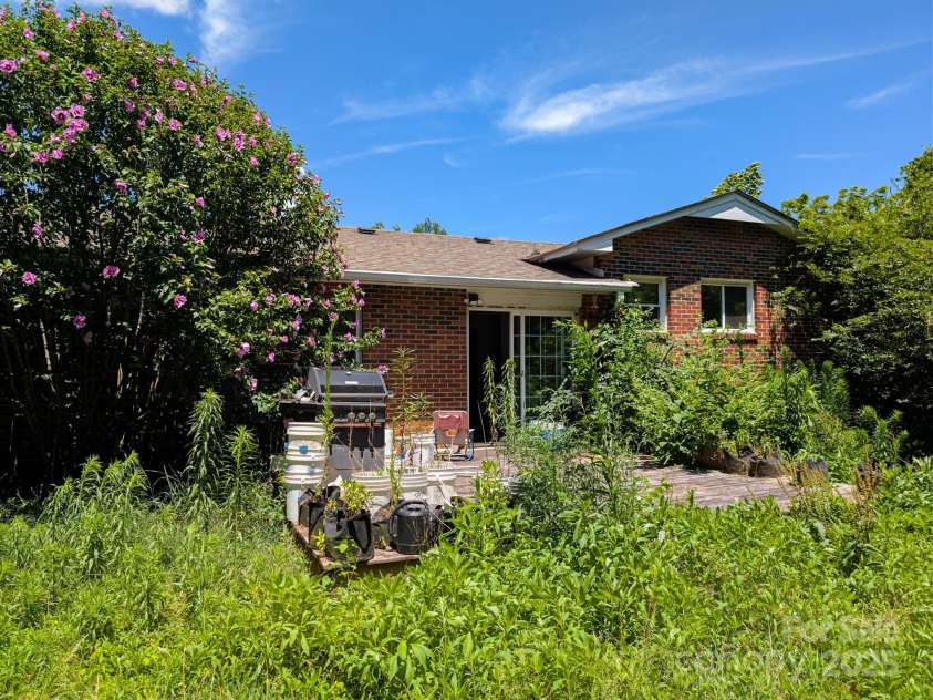 59 Poteat Street, Fletcher, NC 28732.  MLS# CAR4277892, YatesRealty ID 28173. A little overgrown but that's a deck.