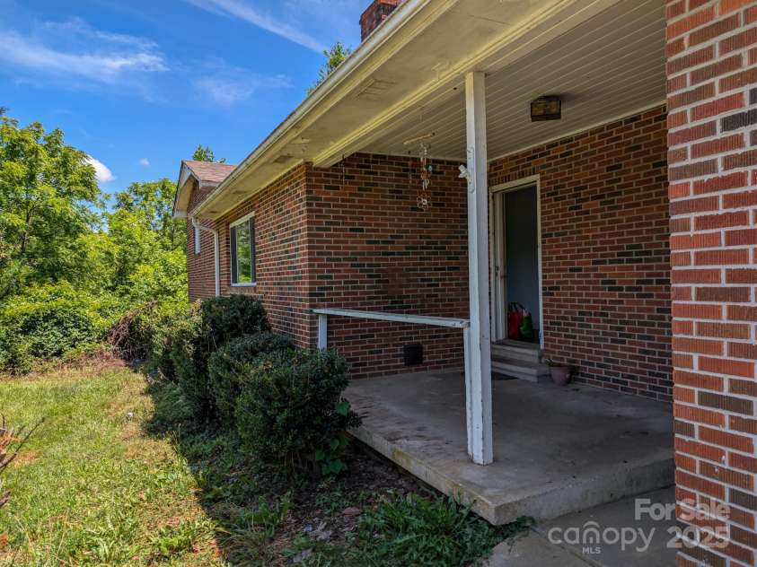 59 Poteat Street, Fletcher, NC 28732.  MLS# CAR4277892, YatesRealty ID 28173. Cute porch on this solid brick home.