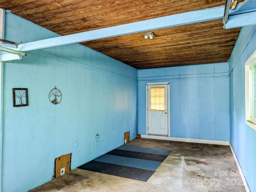 59 Poteat Street, Fletcher, NC 28732.  MLS# CAR4277892, YatesRealty ID 28173. Handy upstairs garage would make an amazing woodshop.