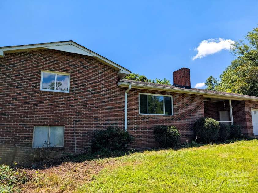 59 Poteat Street, Fletcher, NC 28732.  MLS# CAR4277892, YatesRealty ID 28173. Recently reclaimed yard now makes the home visible.