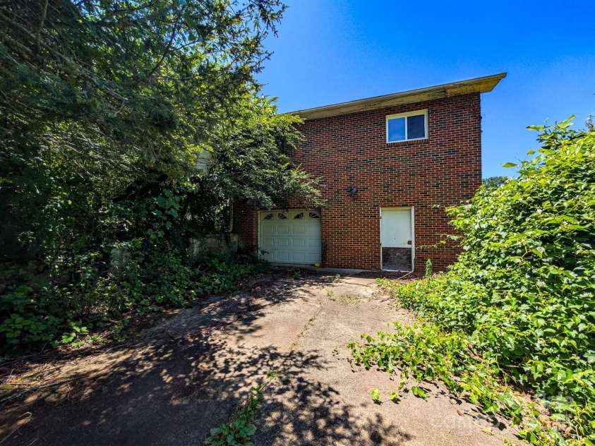 59 Poteat Street, Fletcher, NC 28732.  MLS# CAR4277892, YatesRealty ID 28173. Side garage and parking space below. Super handy for a workshop space since you can pull right up to it.