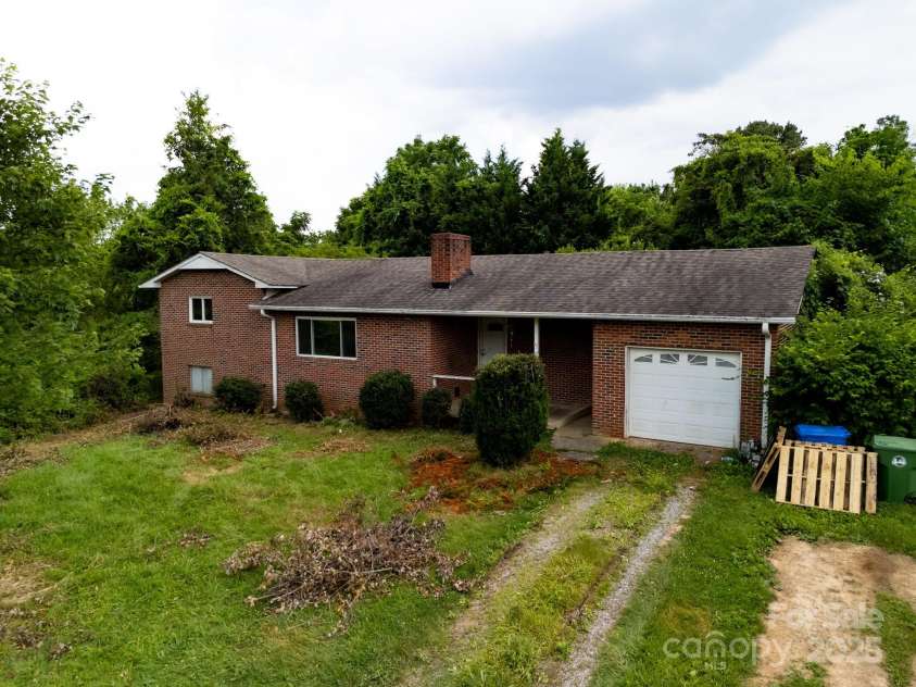 59 Poteat Street, Fletcher, NC 28732.  MLS# CAR4277892, YatesRealty ID 28173. Solid brick house from 1966 fronts the 3.31 acres.