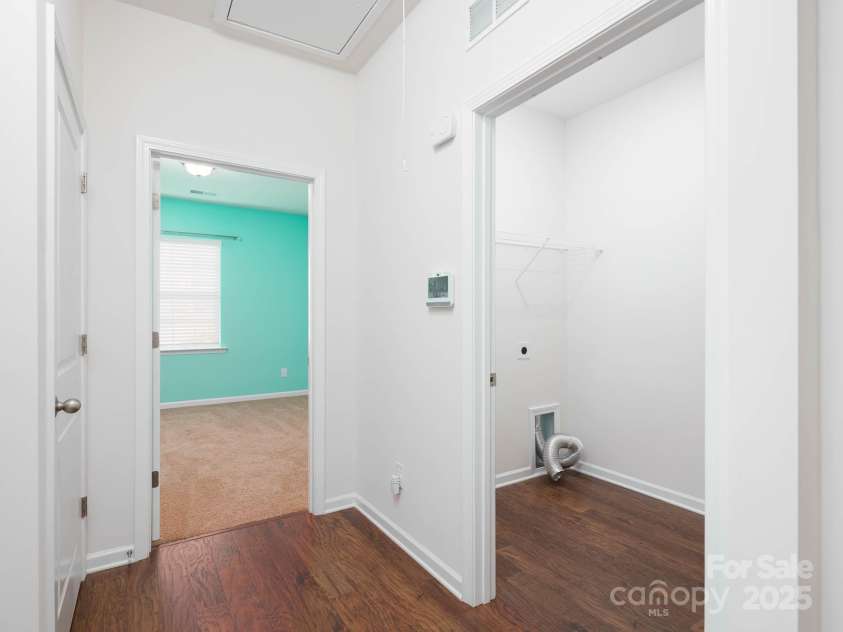 170 Atwater Landing Drive, Mooresville, NC 28117.  MLS# CAR4249384, YatesRealty ID 28180. Back hallway off garage with access to laundry and a secondary bedroom.
